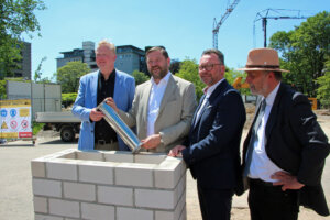 Prof. Dr. Martin Eversmeyer, Oberbürgermeister Tim Kurzbach, Prof. Dr. med. Thomas Standl und Beigeordneter Jan Welzel bei der Grundsteinlegung der neuen Akademie. (Foto © Sandra Grünwald)