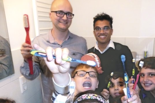 Bei der Infoveranstaltung „Zahngesundheit“ überzeugten sich Dr. Dr. Teut-Kristofer Rust (li.) und Dence Daniels (re.) von der Mund-, Kiefer- und Gesichtschirurgie (MKG) der St. Lukas Klinik davon, dass der Nachwuchs beim Zähneputzen alles richtig macht. (Foto: © Kplus Gruppe)