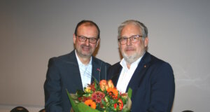 Arnd Krüger (li.) gratuliert seinem Nachfolger Marc Robert Clemens und überreichte ihm zum Amtsantritt als Kreishandwerksmeister einen Blumenstrauß. (Foto: © Kreishandwerkerschaft Solingen-Wuppertal)