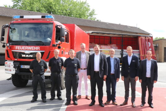 Fahren den Transport ins ostpolnische Chełm: v.li. Markus Klapper, Marcus Klose (Berufsfeuerwehr Solingen) und Kevin Eichelmann (Umweltschutzzug). Machten den Transport möglich: Dr. Martin Eversmeyer (4.v.li., Geschäftsführer Klinikum), Oberbürgermeister Tim Kurzbach, Flüchtlingskoordinator Hartmut Hoferichter, Sparkassenchef Stefan Grunwald und Daniel Banzhaf von den Stadtwerken Solingen. (Foto: © Bastian Glumm)