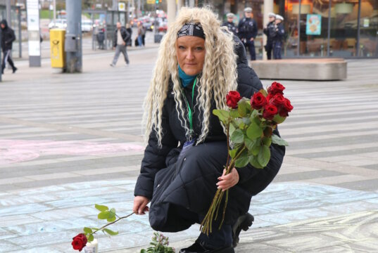 Am Freitagnachmittag startete eine Mahnwache auf dem Walter-Scheel-Platz im Gedenken an die Opfer des russischen Angriffskriegs. Auch mit Blumen gedachte man der Getöteten. Agnieszka Moranska-Röder, Vorsitzende des Vereins „Helfende Schirme Solingen“, legt eine Rose nieder. (Foto: © Bastian Glumm)