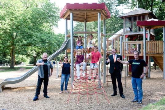 Daumen hoch für das neue Spielgerät auf dem Engelsberger Hof: vorne von links Klaus Podubrin, Silke Baersch, Stefan Röhrig und Uli Baersch sowie auf dem Klettergerüst Henri, Jonas, Carolina und Marie. (Foto: © Volksbank/Anne Stahl)
